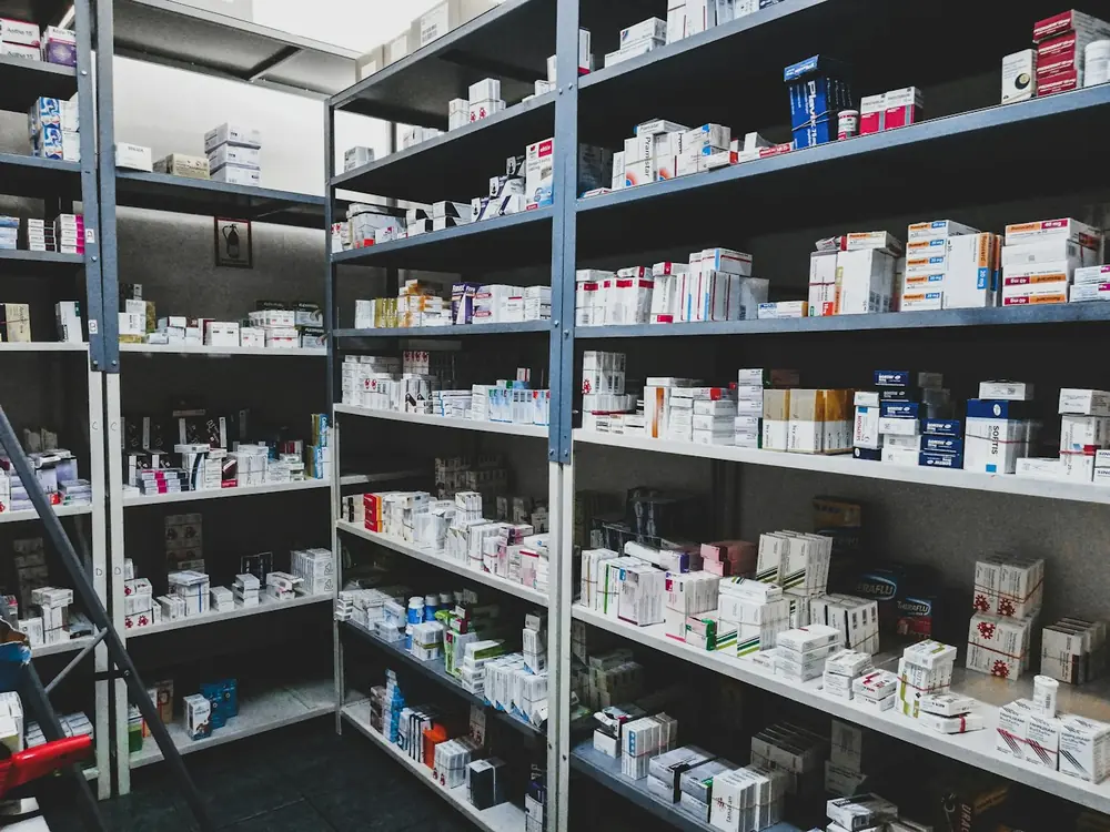 Dispensary shelves stacked with medicine boxes