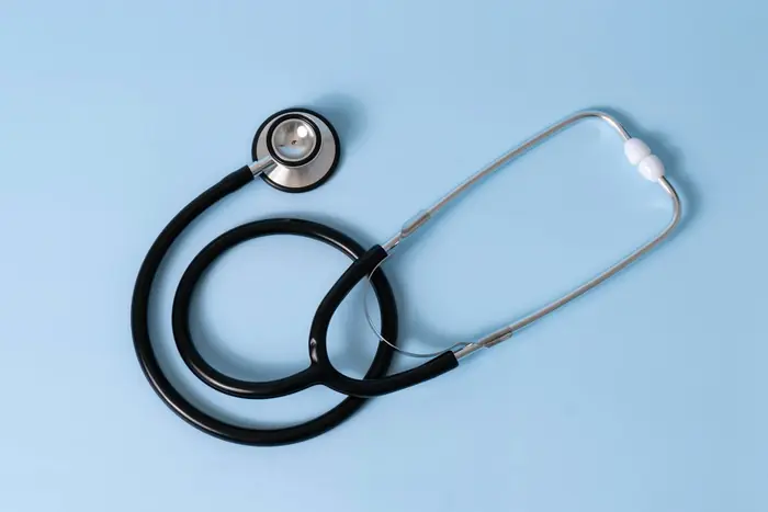 A stethoscope on a pale blue surface